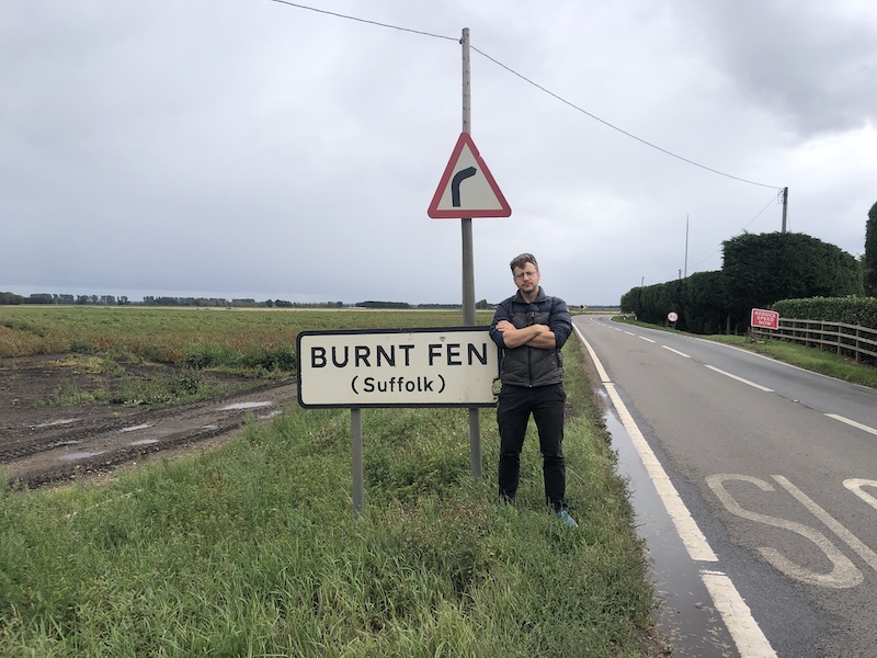 Me standing in front of a burnt fen sign